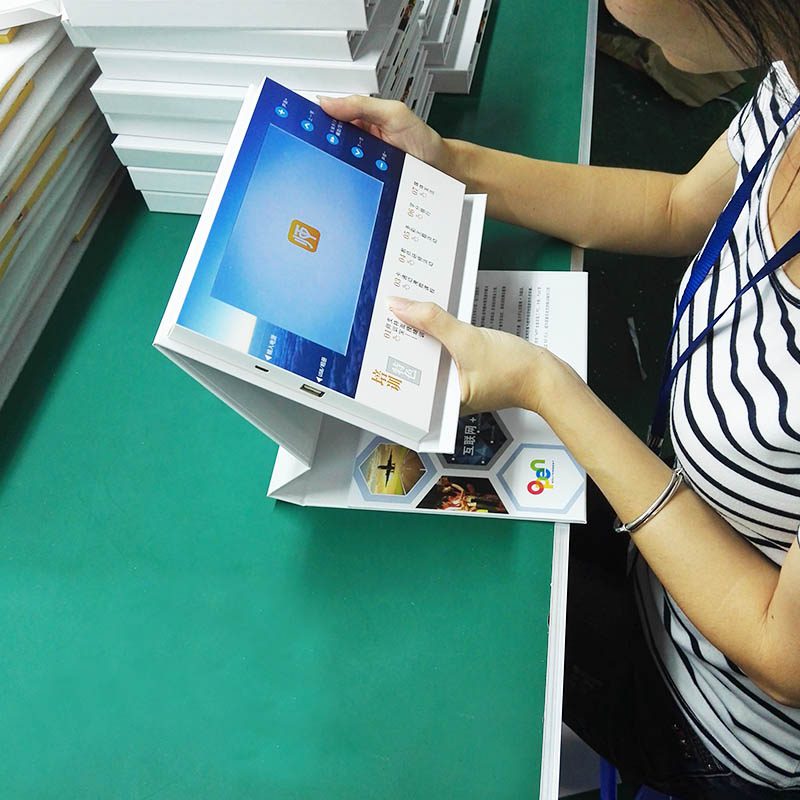 A woman holding an ipad on top of a stand.