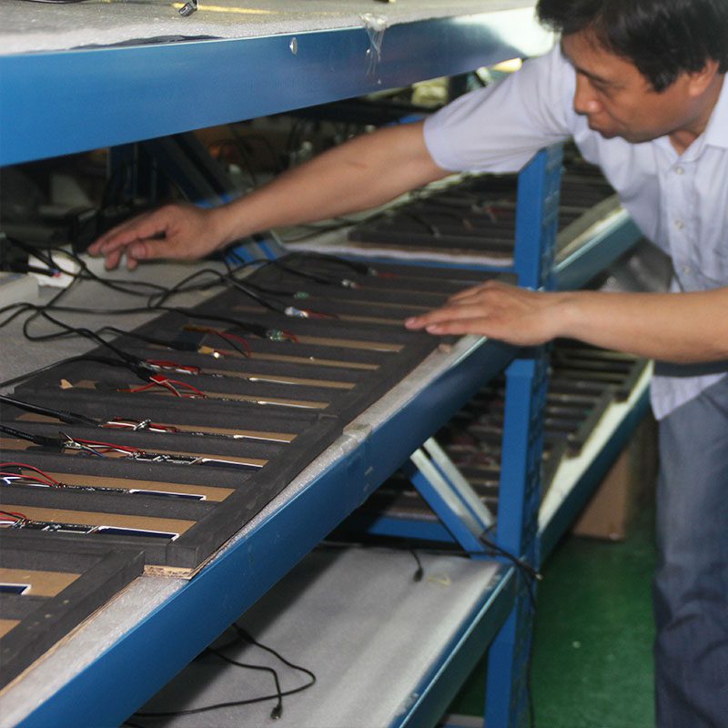 A man working on a conveyor belt in an assembly line.