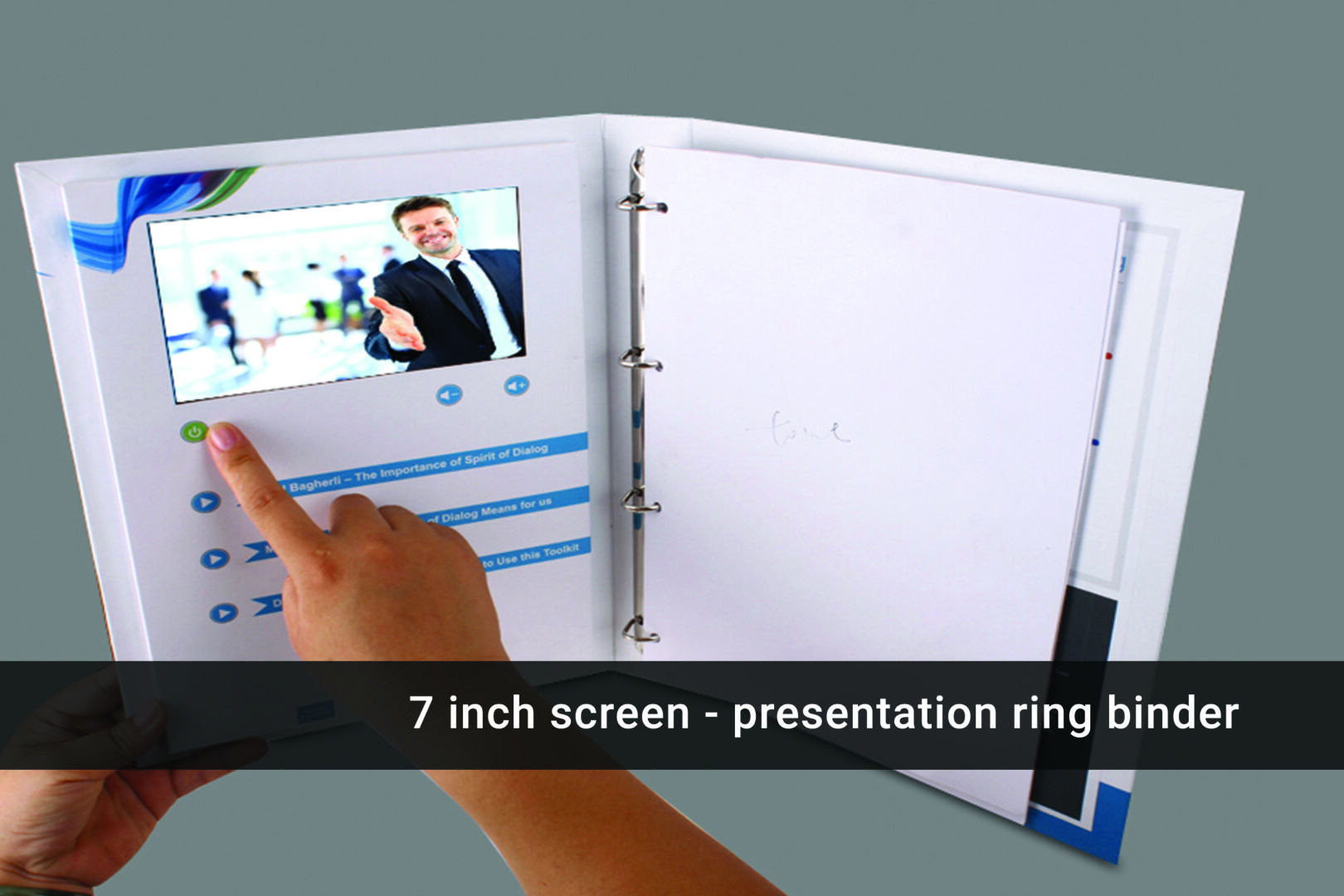 A person is touching the screen of a video presentation ring binder.