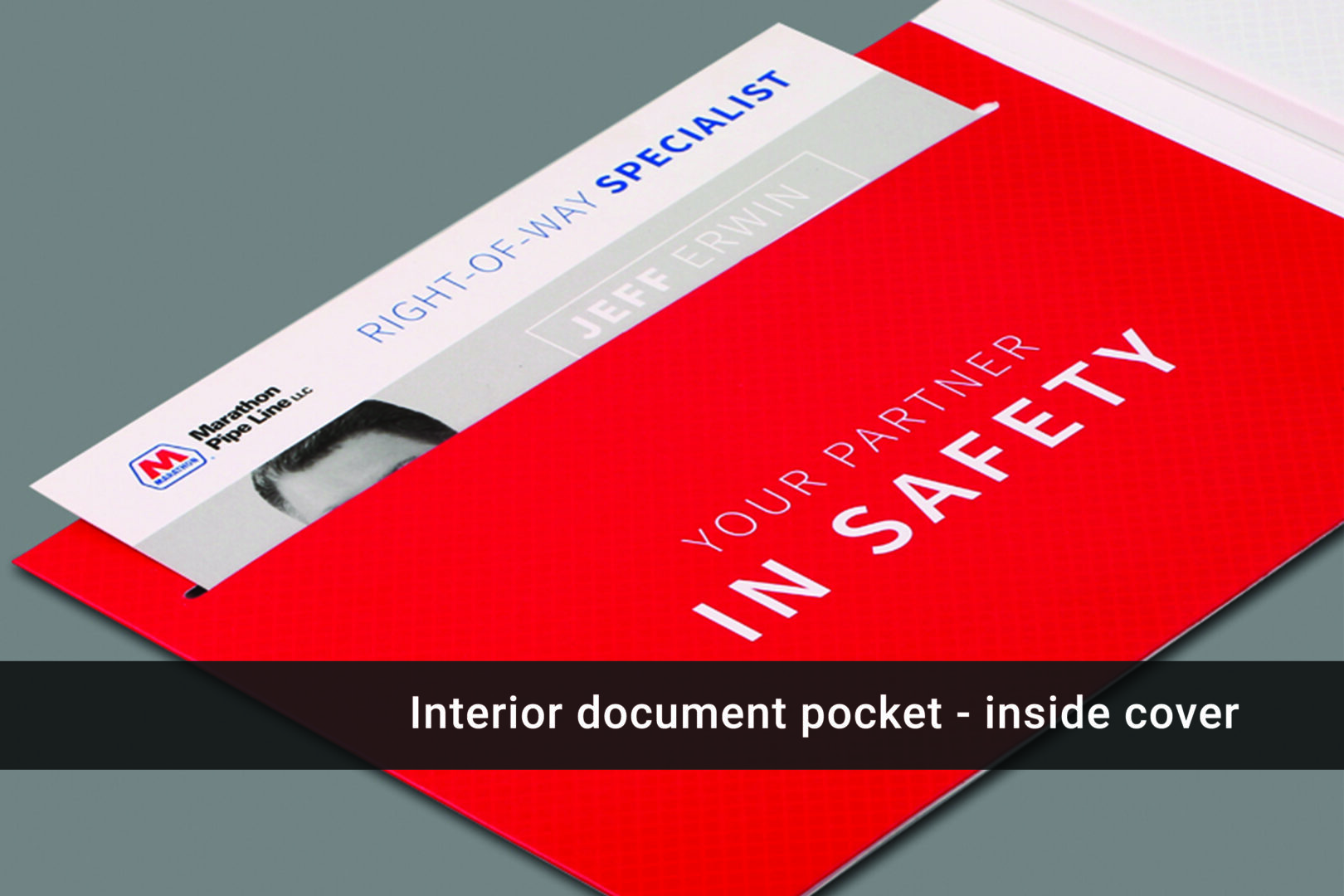 A red folder with the words " your partner in safety " on it.