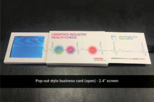 A business card is opened to show the contents.