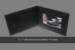 A black leather cover with a picture of a car on it.