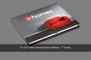 A hard cover brochure with a red couch on it.