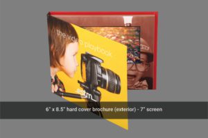 A hard cover brochure with an image of a child and camera.