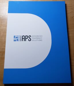 A blue and white book with the word aps on it.