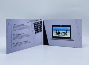 A video brochure is shown with a laptop on the screen.