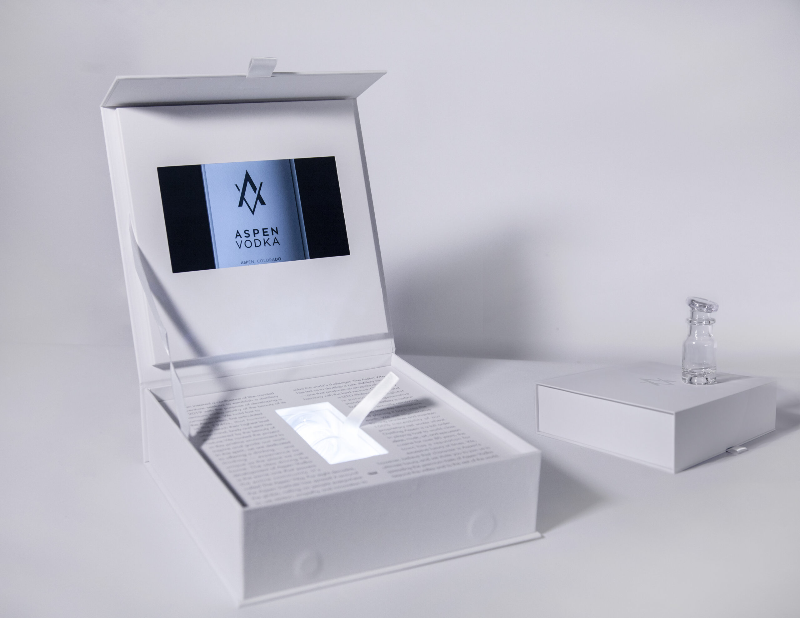 A white box with a pen and a tablet